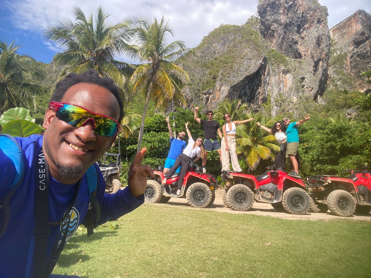Group with ATVs in front of limestone cliffs