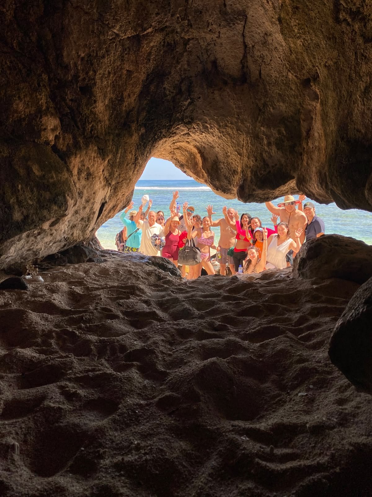 Group waving inside a coastal cave