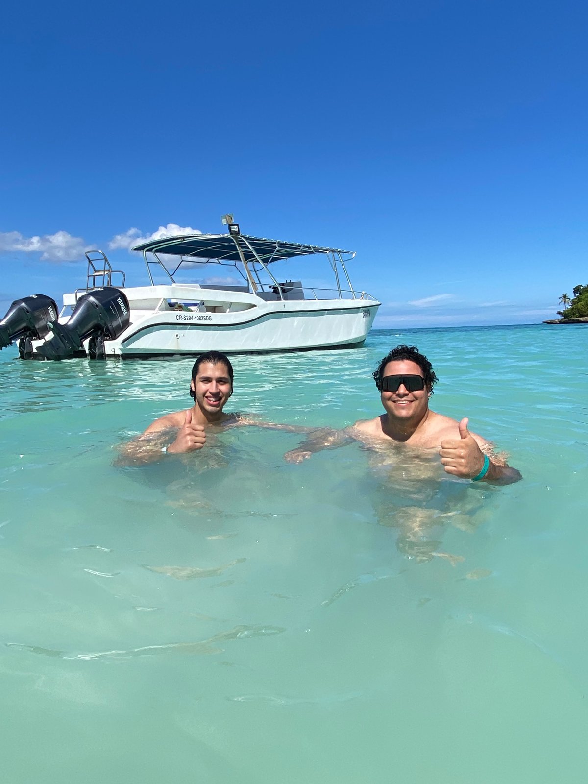 Guests swimming next to the boat at Cayo Levantado