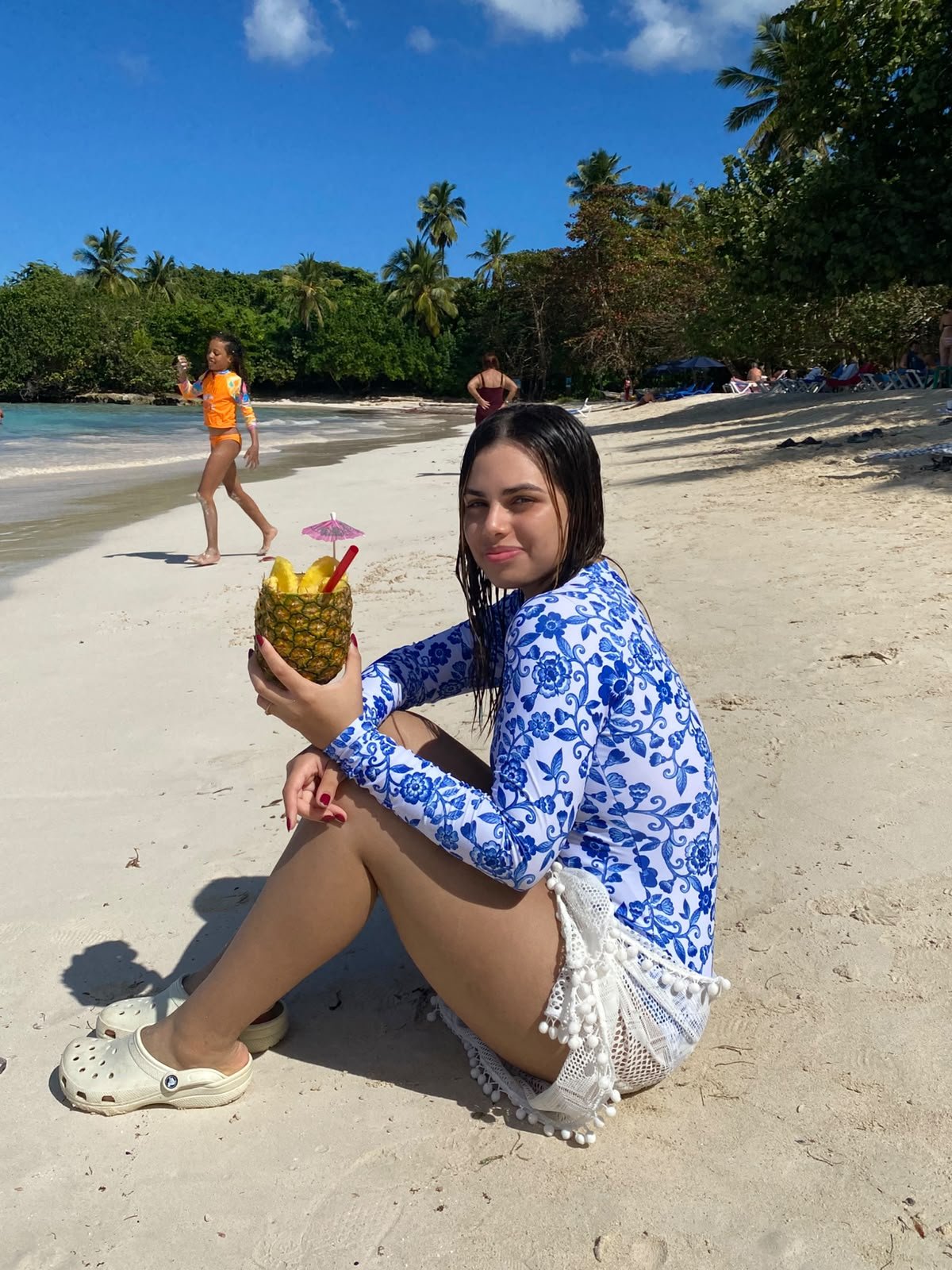 Guest with a pineapple drink on the beach