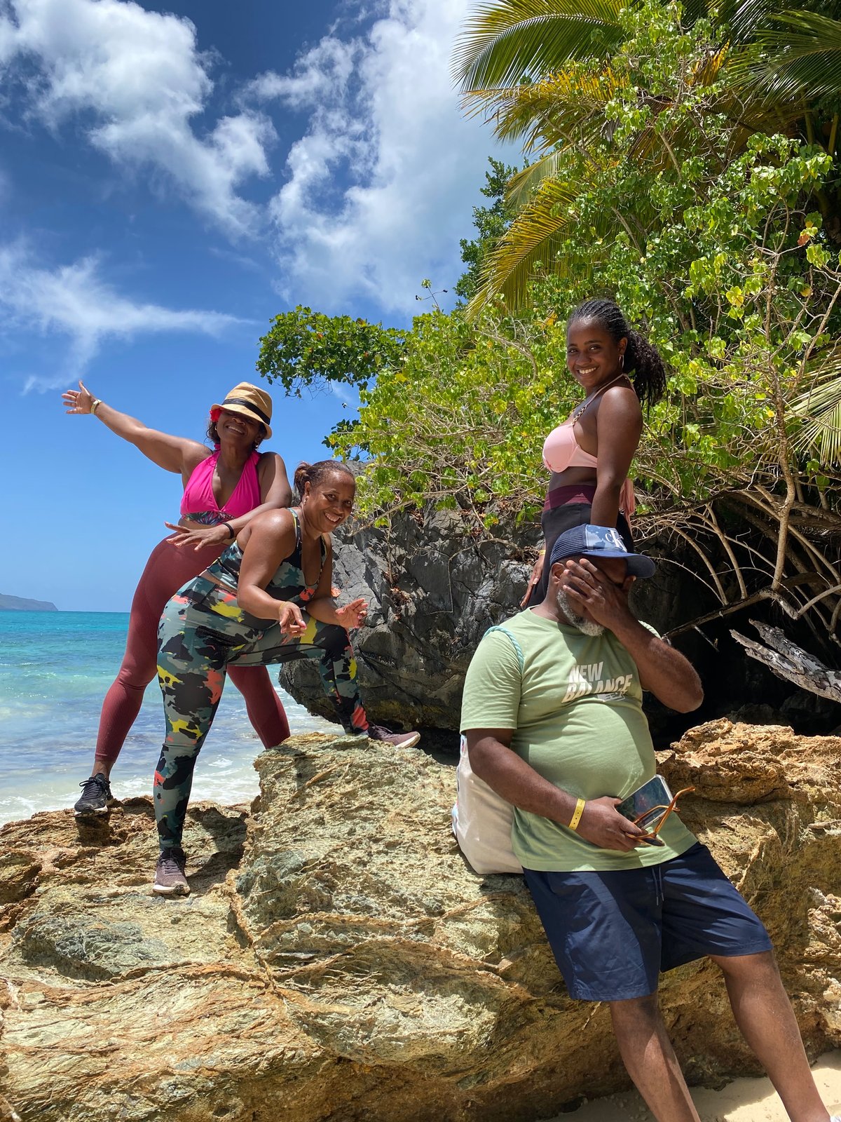Group posing on the rocks along the Seven Beaches trail